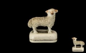 Antique Miniature Staffordshire Figure of a Lamb, with a fritted coat, on a base; 1.