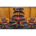 An Oxblood Leather Captain's Chair with buttoned seat and backrest. Height 34 inches.