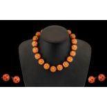 Pink Coral Coloured Bakelite Carved Bead Necklace 16'' in length - together with a pair of earrings,
