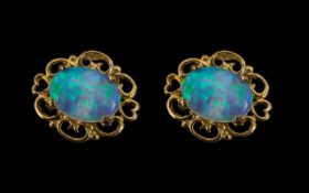 A Pair of 9ct Gold Opal Stud Earrings, Post and butterfly fastening. 10 by 8 mm.