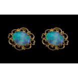 A Pair of 9ct Gold Opal Stud Earrings, Post and butterfly fastening. 10 by 8 mm.