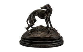 Early 20th Century Reproduction Bronze Figure Of A Greyhound Raised on an ebonised oval base,