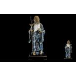 Large Chinese Stoneware Blue Glazed Figure of a Sage holding the peach of immortality and a staff,