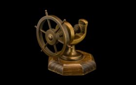 Novelty Nut Cracker in the form of a ship's wheel, made of brass on an oak base.