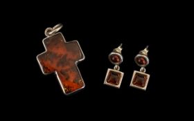 A Modern Silver Mounted Amber Pendant in the form of a cross. Together with a pair of amber set drop