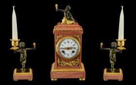 French Clock Garniture. A pink marble and ormolu mounted clock garniture. The case of rectangular