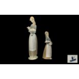 Lladro Handpainted Porcelain Figures (2). 1. Young woman carrying a lamb. Height 10.5" - 26.5 cm.