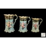 Set of Three Graduated Victorian Pottery Floral Decorated Milk Jugs on a turquoise coloured ground