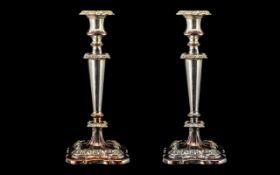 Pair of Antique Sheffield Plate Candlesticks, with applied moulded decorations on shaped bases.