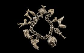 A Superb, Large & Impressive Sterling Silver Charm Bracelet loaded with 9 large silver charms,