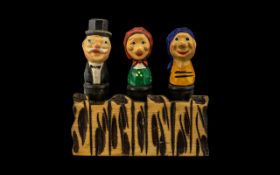 Novelty Wine Stoppers. Hand made and painted set of three on a stand, all with humorous faces.