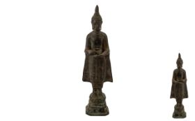 Antique Bronze Figure of a Standing Buddha, holding a ritual vessel,