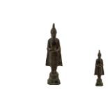 Antique Bronze Figure of a Standing Buddha, holding a ritual vessel,