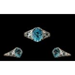 Sky Blue Topaz Solitaire Type Ring, an oval cut blue topaz of 5cts set in a milgrain frame,