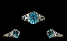 Sky Blue Topaz Solitaire Type Ring, an oval cut blue topaz of 5cts set in a milgrain frame,