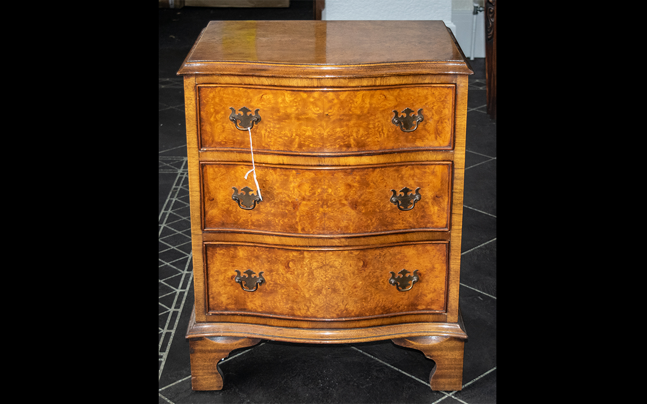 A Reproduction Small Serpentine Fronted Chest of Three Drawers in burr walnut,