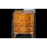 A Reproduction Small Serpentine Fronted Chest of Three Drawers in burr walnut,