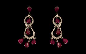 Ruby Loops and Drops Long Earrings, each earring comprising a total of six pear cut rubies of red