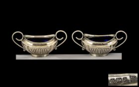 Pair of Silver Condiment Pots with blue glass liners. Hallmarked Sheffield 1907.