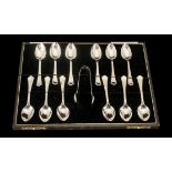 A Boxed Set of 12 Sterling Silver Teaspoons with Matching Sugar Nips.