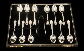 A Boxed Set of 12 Sterling Silver Teaspoons with Matching Sugar Nips.