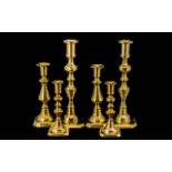 Three Pairs of Brass Candlesticks traditional style candlesticks, measuring 12", 8.5" and 7".