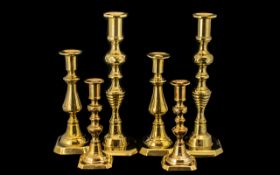 Three Pairs of Brass Candlesticks traditional style candlesticks, measuring 12", 8.5" and 7".