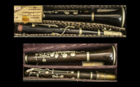 Two Vintage Clarinets, both in hard shell leather cases, with spare reeds. Maker F.