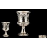 Victorian Period Solid Silver Drinking Vessel with embossed floral decorations to body.
