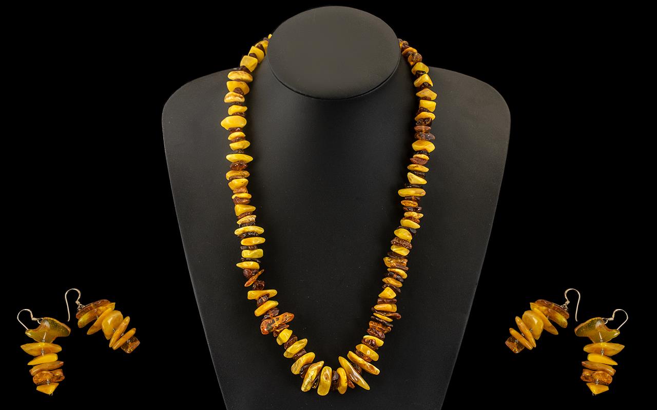 A Modern Reconstituted Amber Free form Necklace. Length 22 inches. Together with a pair of amber