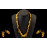 A Modern Reconstituted Amber Free form Necklace. Length 22 inches. Together with a pair of amber
