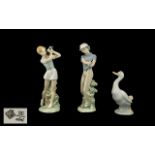 Three Nao Figures, comprising a lady golfer 9.5" tall, a gentleman golfer 9.