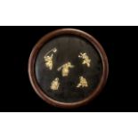A Japanese Round Lacquered Wall Plaque with applied carved figures in bone of boys playing various
