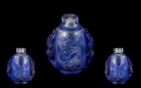 Chinese Blue Cameo Glass Snuff Bottle, carved to the body with dragons and phoenix birds,