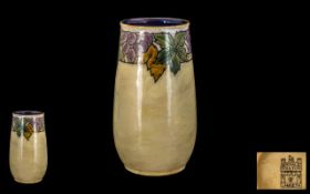 Royal Doulton Lambeth Vase of Chimney Shape decorated with berries and holly design. Circa 1910.