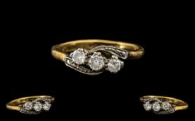 An Antique 18ct Three Stone Diamond Ring set on a twist.