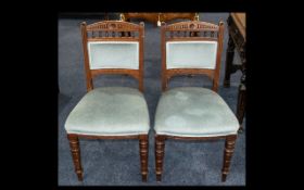 A Pair of Edwardian Oak Salon Chairs with turned legs, upholstered in blue velour back and seat.