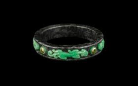 Oriental Bangle of Unusual Form, green stone chilogs applied to the grey marble body of the bangle,