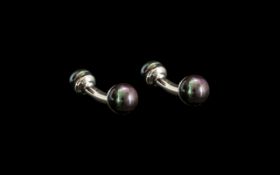 Fresh Water Peacock Pearl Cufflinks, each comprising a solid, curved,