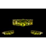 Peridot Graduated Band Ring, five oval cut peridots graduated slightly to either side of the