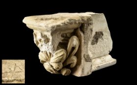 An Antique Fragmentary Limestone Corbel, with a deeply carved floral design,