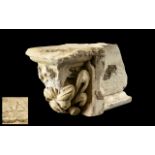 An Antique Fragmentary Limestone Corbel, with a deeply carved floral design,