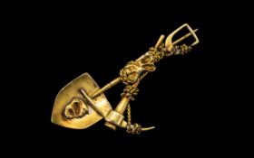 Unusual 14ct Gold Brooch in the form of a Pickaxe, Spade and Large Gold Nugget, entwined by a rope.