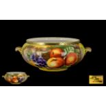 Porcelain Painted Bowl with Gilt Side Handles, depicting fruit on a mossy bank, signed N.