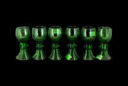 A Set of Six German Green Coloured Hock Glasses with applied lion masks to the stem on a ribbed