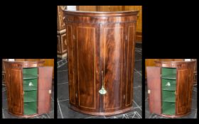 A Georgian Mahogany Double Door Inlaid Corner Cupboard with fitted shelves to the interior and a