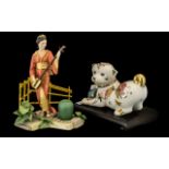 Two Porcelain Figures comprising a decorative Oriental style dog from the Franklin Mint, 'The