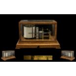 Negretti and Zambra London Barograph fitted into a golden oak case with bevelled glass panels and a