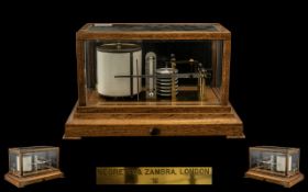 Negretti and Zambra London Barograph fitted into a golden oak case with bevelled glass panels and a