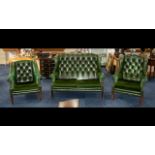 A Three Piece Button Back Green Leather Chesterfield to include a two seater high winged back and